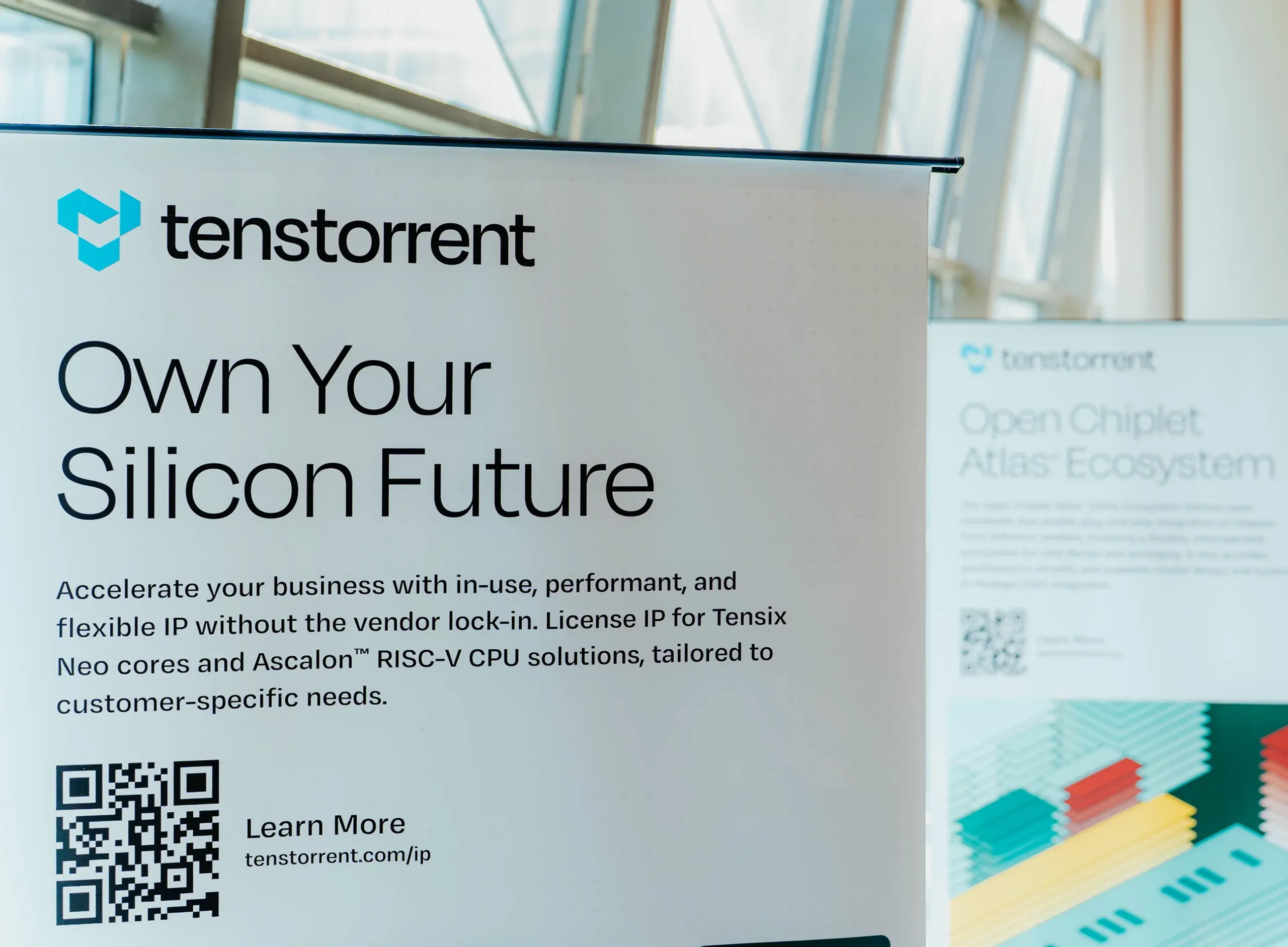 Tenstorrent "Own Your Silicon Future" roll-up banner with QR code at The Open Frontier venue
